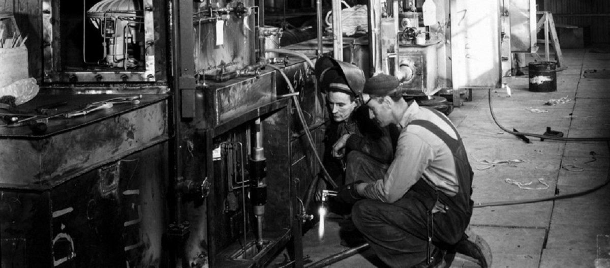 Photograph of two workers inside the K-25 plant in Oak Ridge, TN