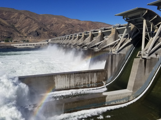 Water rushes through a dam